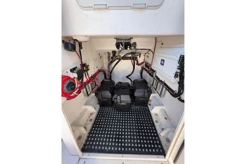 Slide: The Image of Electrical compartment of a 2003 Contender 23 Open boat with wiring and battery setup. - 9