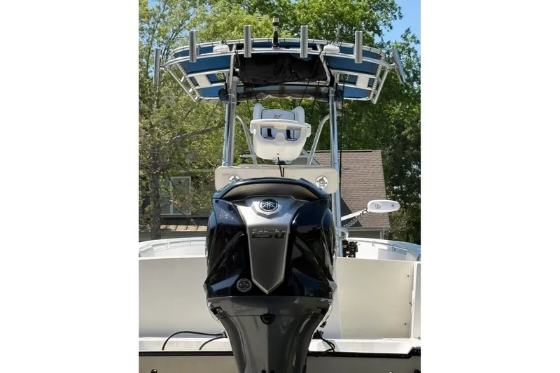 Slide: The Image of 2003 Contender 23 Open boat with powerful outboard motor, viewed from the rear. - 5