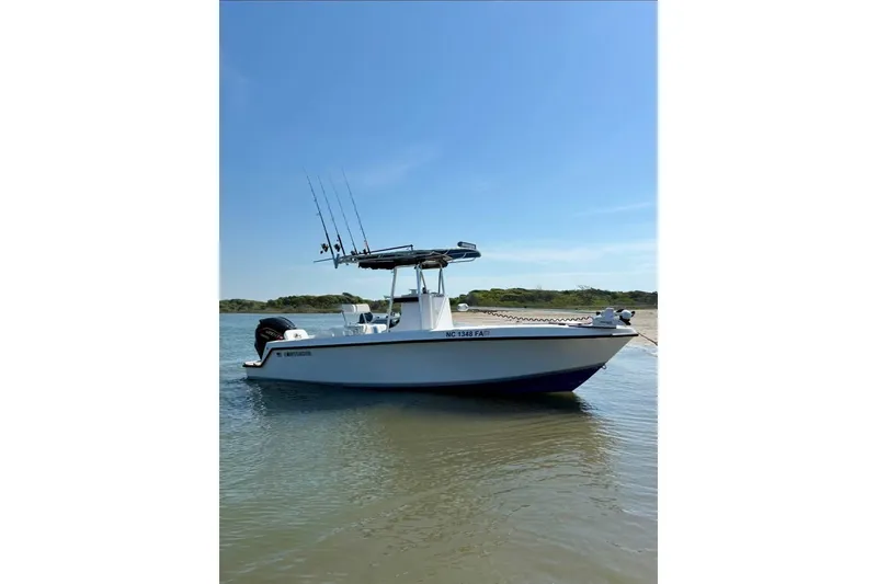 The Image of 2003 Contender 23 Open boat anchored in calm waters under a clear blue sky. - 0