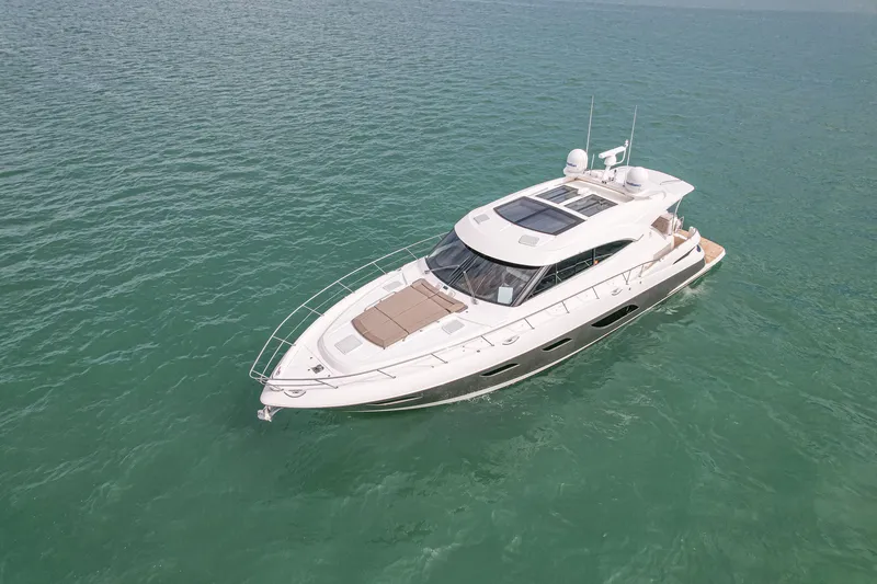 Slide: The Image of 2015 Riviera 6000 Sport Yacht cruising on calm blue waters. - 10