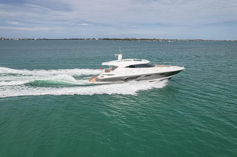 Slide: The Image of 2015 Riviera 6000 Sport Yacht cruising on open water under a clear sky. - 17