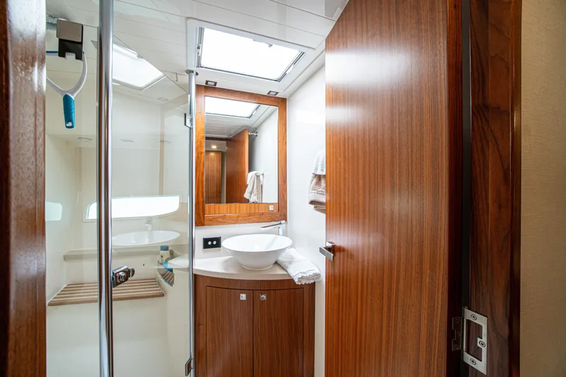 Slide: The Image of Luxurious bathroom interior of 2015 Riviera 6000 Sport Yacht with wood accents and modern fixtures. - 57