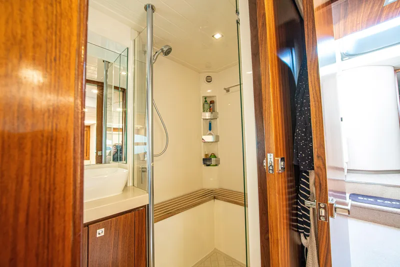 Slide: The Image of Luxurious bathroom interior of 2015 Riviera 6000 Sport Yacht with wooden accents. - 55
