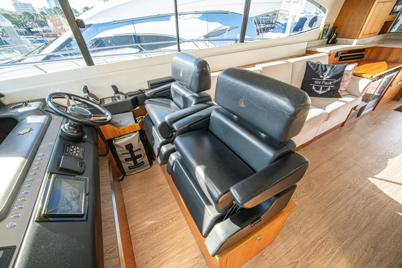 Slide: The Image of Interior of 2015 Riviera 6000 Sport Yacht with leather seating and helm station. - 36