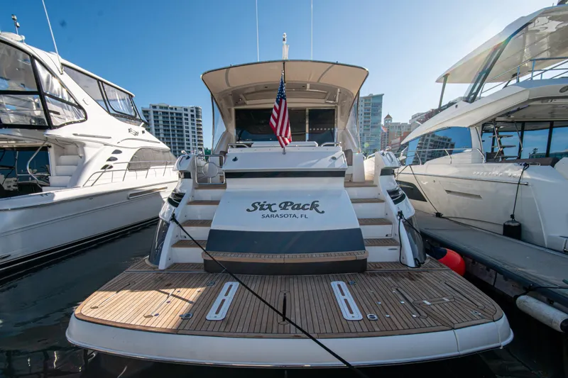 Slide: The Image of 2015 Riviera 6000 Sport Yacht docked in Sarasota, FL, with American flag displayed. - 21