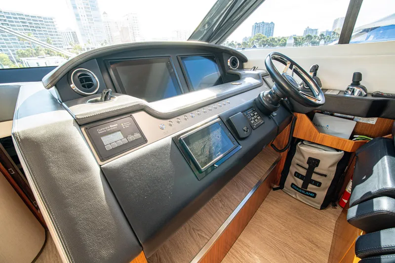 Slide: The Image of Cockpit of 2015 Riviera 6000 Sport Yacht with modern navigation controls and steering wheel. - 37
