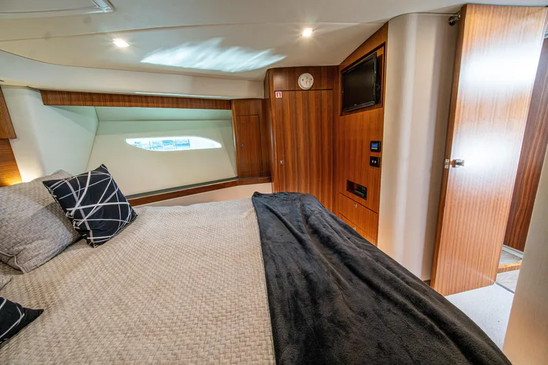 Slide: The Image of Luxurious interior of 2015 Riviera 6000 Sport Yacht bedroom with modern design elements. - 59