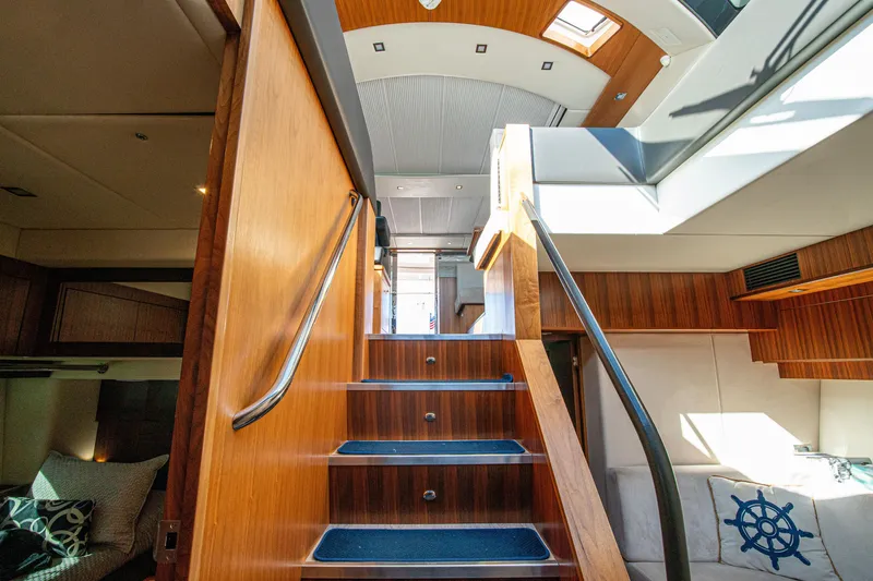 Slide: The Image of Interior view of 2015 Riviera 6000 Sport Yacht with wooden stairs and modern design. - 40