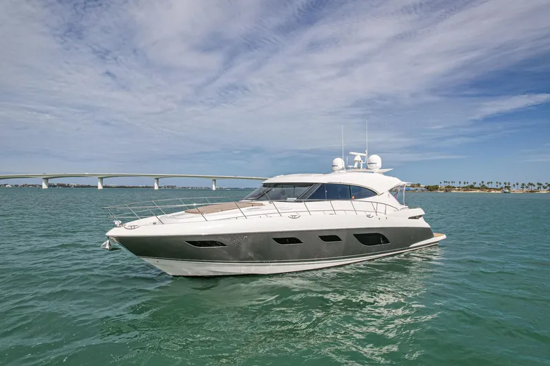Slide: The Image of 2015 Riviera 6000 Sport Yacht cruising on open water under a clear sky. - 3