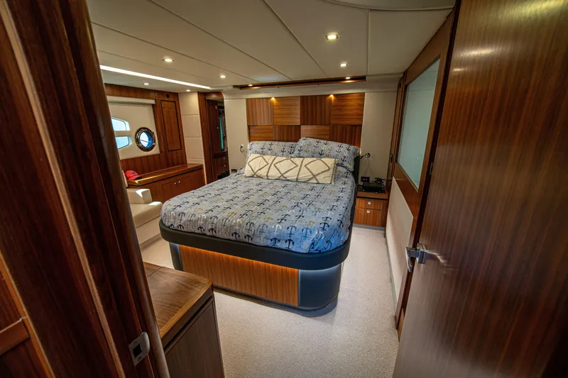 Slide: The Image of Luxurious bedroom interior of 2015 Riviera 6000 Sport Yacht with elegant wood finishes. - 48