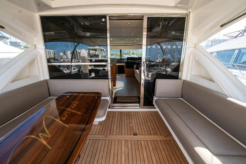 Slide: The Image of Luxurious 2015 Riviera 6000 Sport Yacht interior with elegant seating and polished wood table. - 27
