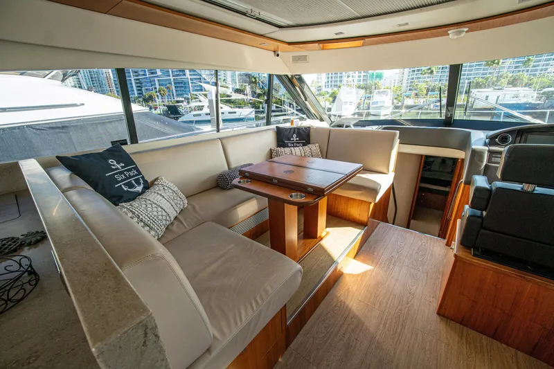 Slide: The Image of Luxurious interior of 2015 Riviera 6000 Sport Yacht with elegant seating and wooden table. - 31