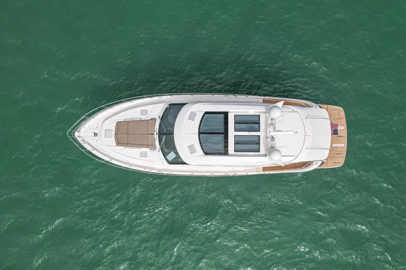 Slide: The Image of Aerial view of 2015 Riviera 6000 Sport Yacht on green water. - 11