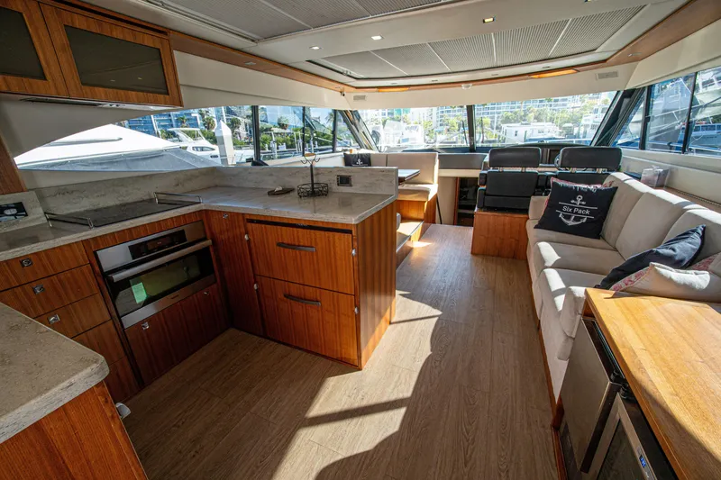 Slide: The Image of Luxurious interior of 2015 Riviera 6000 Sport Yacht with modern kitchen and seating area. - 28