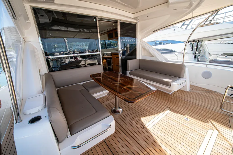 Slide: The Image of Luxurious 2015 Riviera 6000 Sport Yacht interior with elegant seating and wooden table. - 26