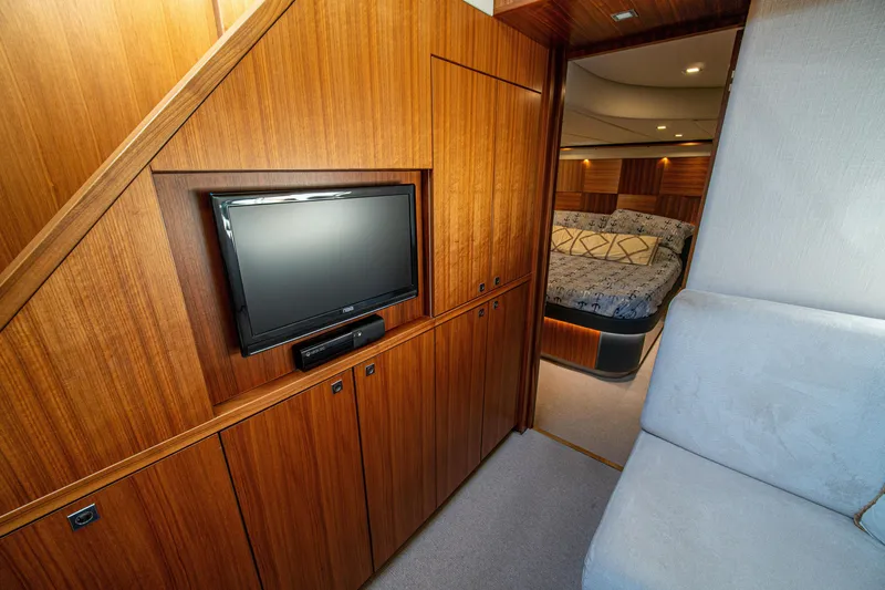 Slide: The Image of Luxurious interior of 2015 Riviera 6000 Sport Yacht with wood paneling and cozy bedroom. - 47