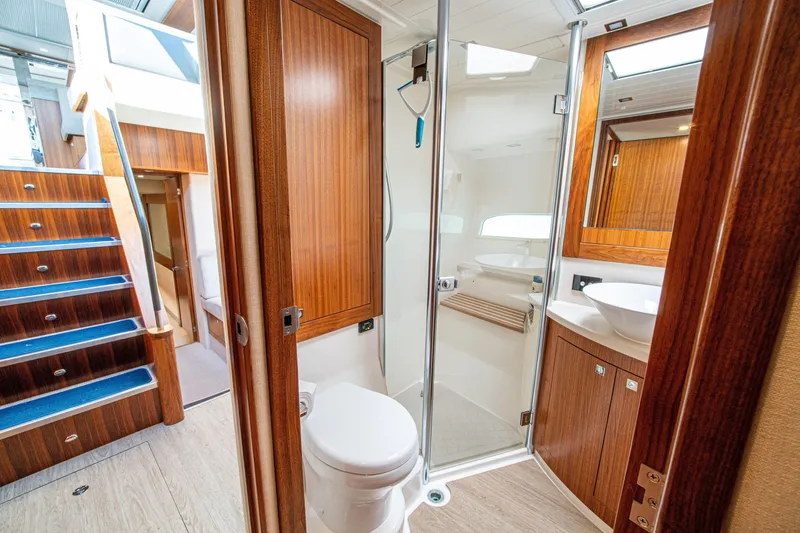Slide: The Image of Luxurious bathroom interior of 2015 Riviera 6000 Sport Yacht with wooden finishes. - 58