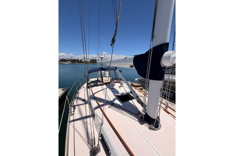 Slide: The Image of 2002 Sabre 362 sailboat deck view with rigging, docked in a marina under clear skies. - 24