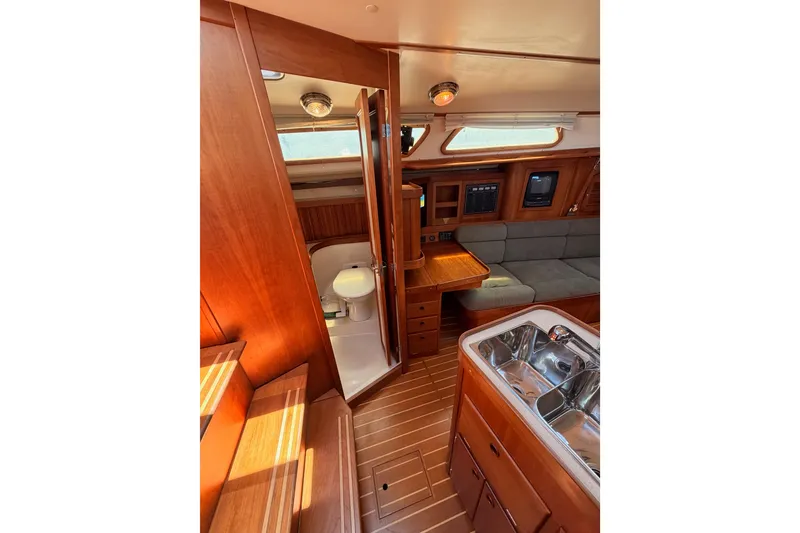 Slide: The Image of Interior of 2002 Sabre 362 yacht featuring wood finish, galley, and seating area. - 56