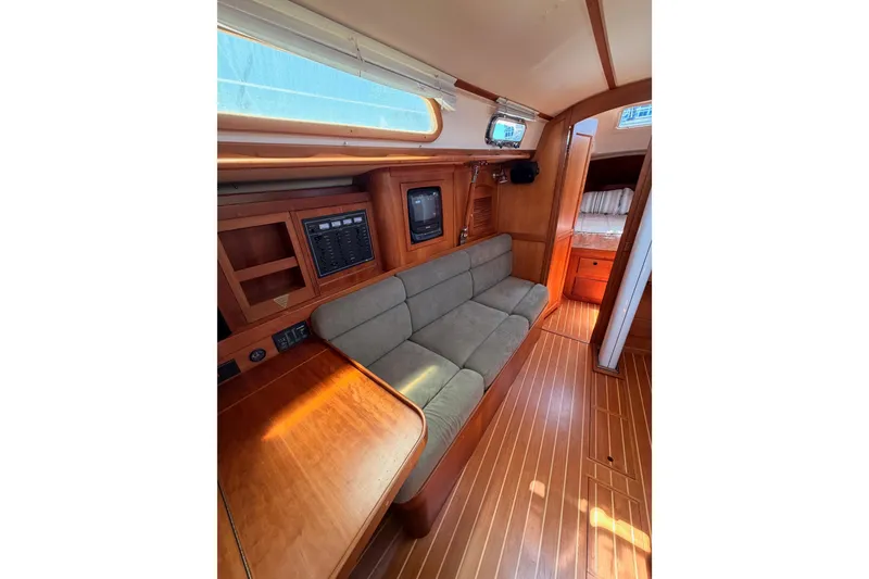 Slide: The Image of Interior of 2002 Sabre 362 yacht with wooden finish and cozy seating area. - 75