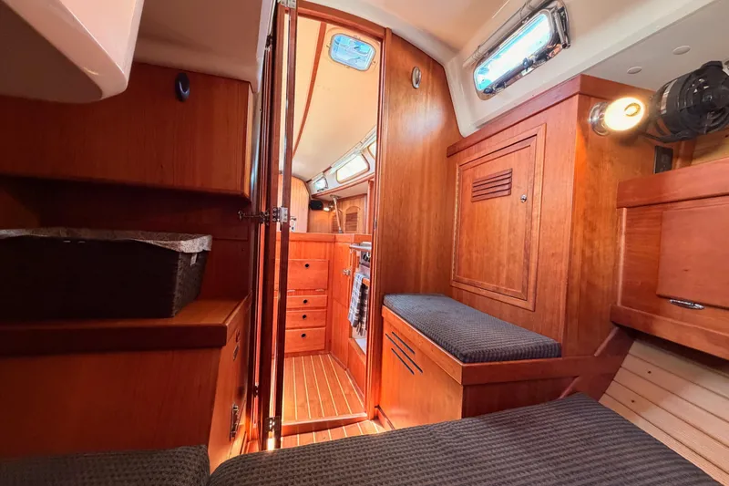 Slide: The Image of Interior of 2002 Sabre 362 sailboat with wooden cabinetry and cozy seating. - 54