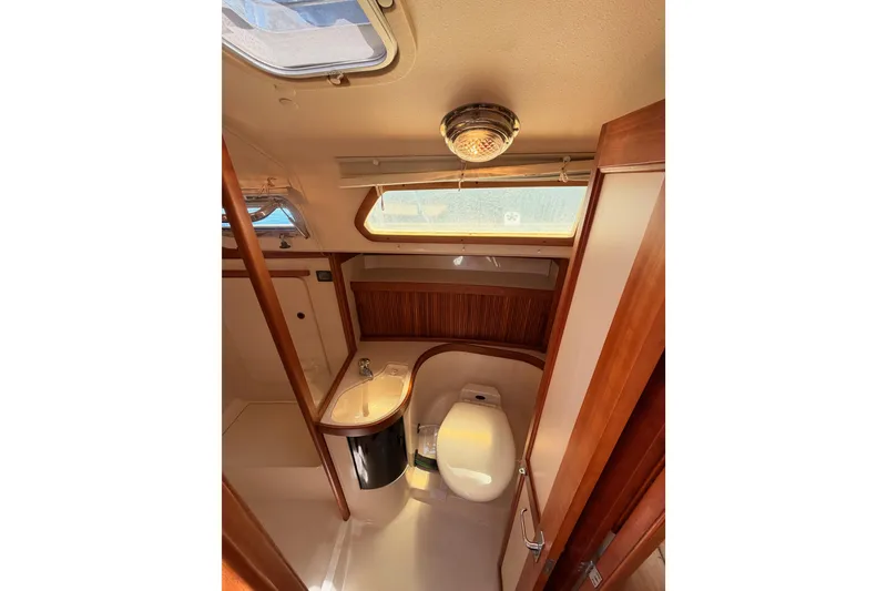Slide: The Image of Interior of 2002 Sabre 362 yacht bathroom with wooden accents and skylight. - 57