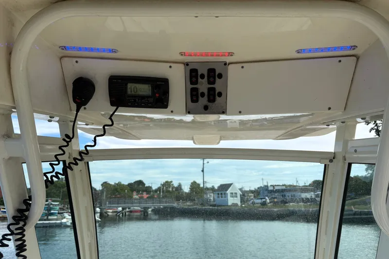 Slide: The Image of Interior view of a 2014 Scout 225 XSF boat with control panel and radio. - 24