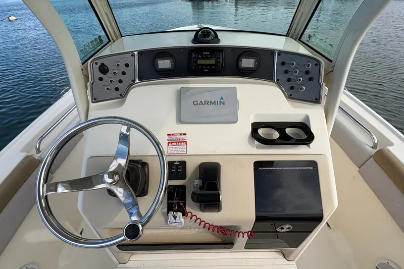 Slide: The Image of 2014 Scout 225 XSF boat dashboard with Garmin navigation system and steering wheel. - 22
