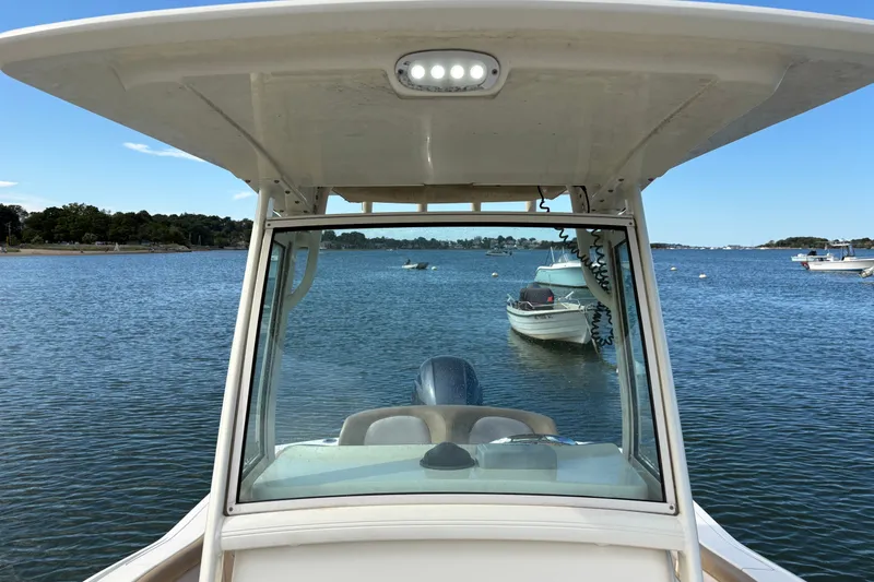 Slide: The Image of 2014 Scout 225 XSF boat on calm water with clear sky. - 28