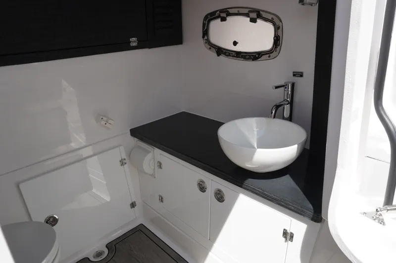 Slide: The Image of Modern bathroom interior on 2027 Monterey Elite 30 OB boat, featuring sleek sink and fixtures. - 23