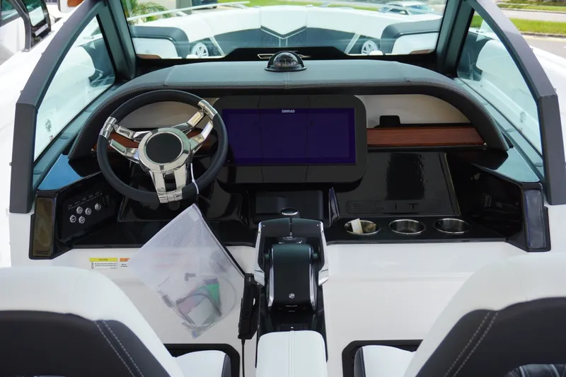 Slide: The Image of 2027 Monterey Elite 30 OB boat dashboard with steering wheel and digital display. - 13