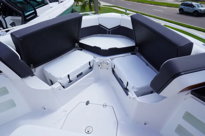 Slide: The Image of Luxury seating area on 2027 Monterey Elite 30 OB boat with coolers. - 18