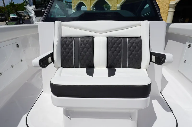 Slide: The Image of Luxury seating on 2027 Monterey Elite 30 OB boat, featuring black and white upholstery. - 20