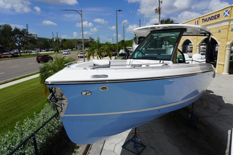 The Image of 2027 Monterey Elite 30 OB boat displayed outdoors on a sunny day. - 0