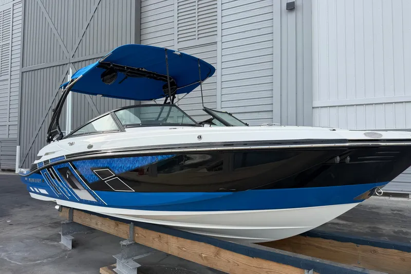 Slide: The Image of 2017 Monterey M-45 boat with blue accents, docked indoors. - 3