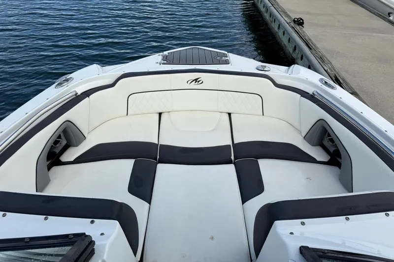 Slide: The Image of 2017 Monterey M-45 boat interior with cushioned seating, docked by the water. - 16
