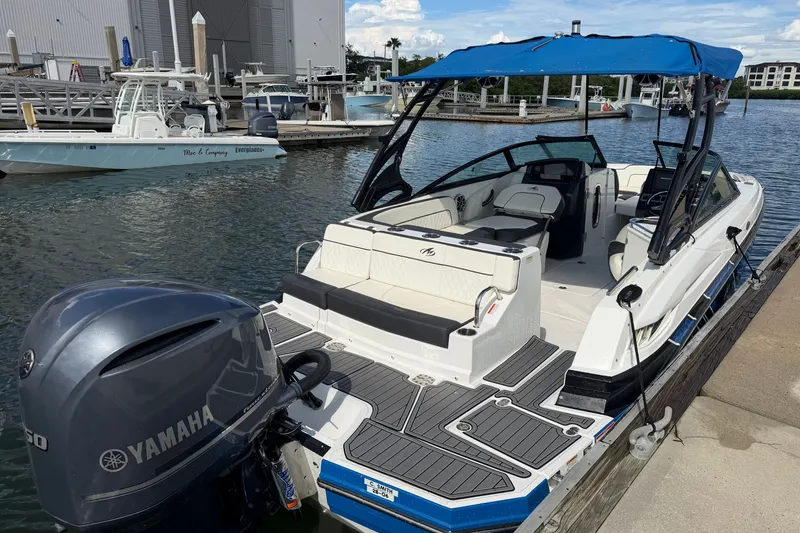 Slide: The Image of 2017 Monterey M-45 boat docked with Yamaha outboard motor, blue canopy, and spacious seating. - 7