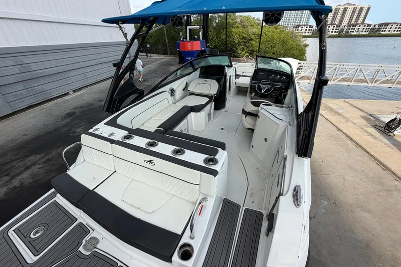Slide: The Image of 2017 Monterey M-45 boat with blue canopy docked near waterfront buildings. - 10