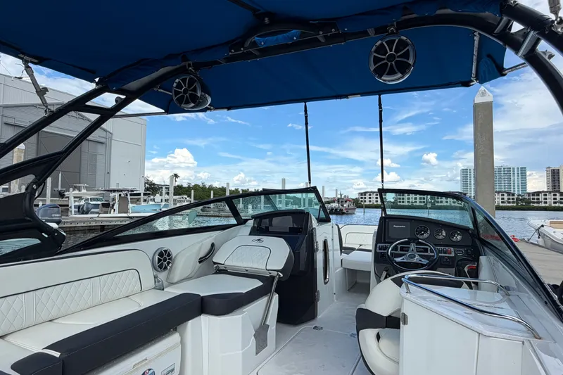 Slide: The Image of 2017 Monterey M-45 boat interior with blue canopy, docked at marina. - 12