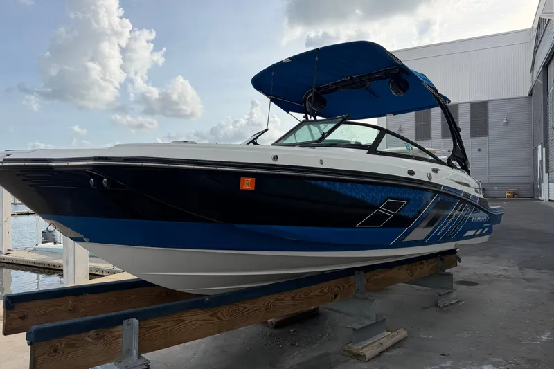 Slide: The Image of 2017 Monterey M-45 boat with blue and white design on a dock. - 5
