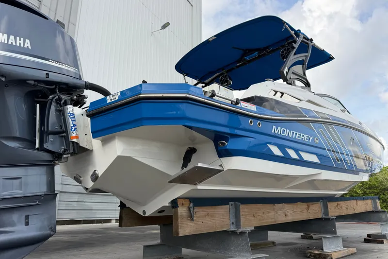 Slide: The Image of 2017 Monterey M-45 boat with Yamaha engine, displayed on a stand outdoors. - 6
