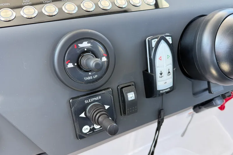 Slide: The Image of Control panel of 2024 Axopar 29 XC Cross Cabin with joystick and switches. - 16