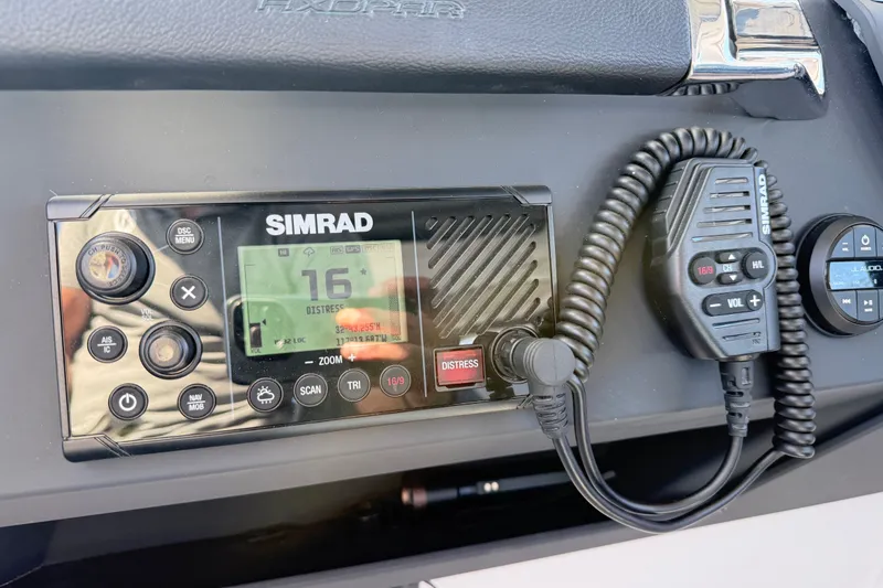 Slide: The Image of Simrad marine radio system on 2024 Axopar 29 XC Cross Cabin dashboard. - 17