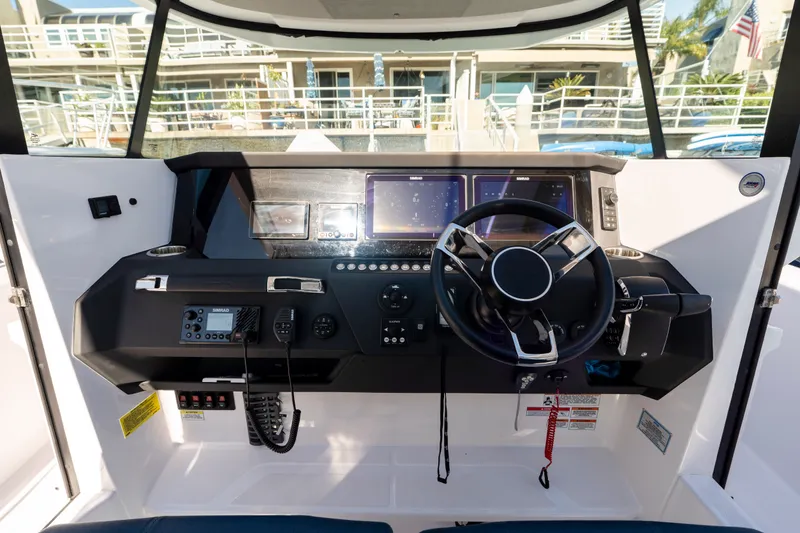 Slide: The Image of 2024 Axopar 29 XC Cross Cabin helm with modern controls and navigation displays. - 7