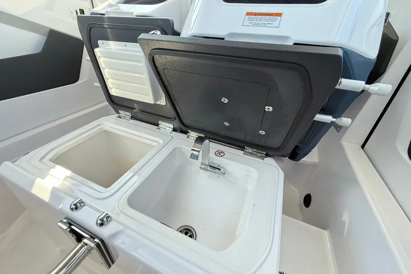 Slide: The Image of 2024 Axopar 29 XC Cross Cabin sink and storage compartment detail. - 18