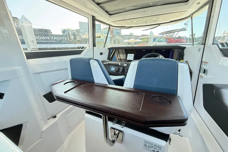 Slide: The Image of 2024 Axopar 29 XC Cross Cabin interior with modern seating and dashboard. - 14