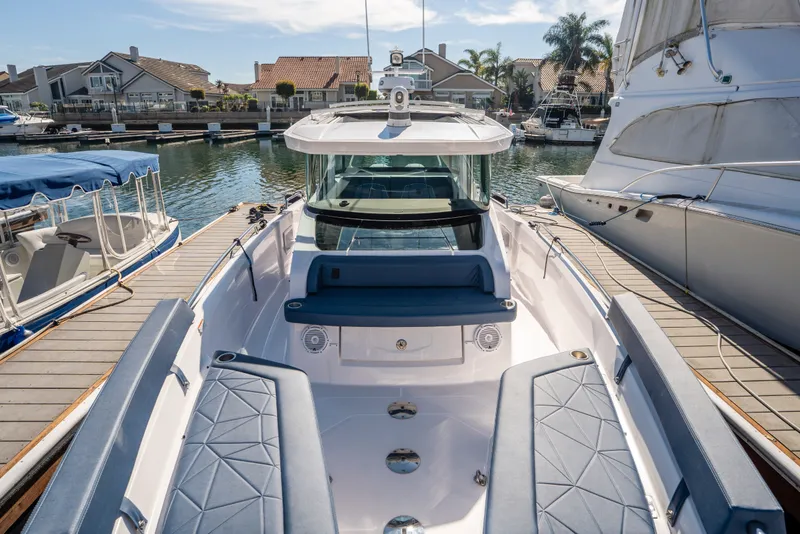 Slide: The Image of 2024 Axopar 29 XC Cross Cabin docked, showcasing sleek design and spacious seating. - 6