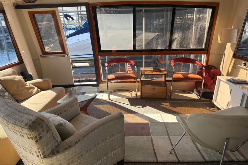 Slide: The Image of Interior of 1987 Californian 53 Cockpit Motor Yacht with cozy seating and large windows. - 15