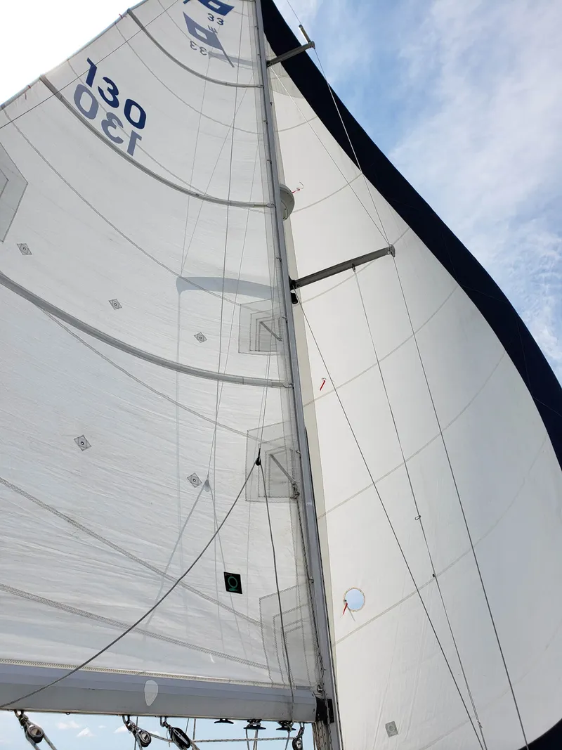 Slide: The Image of The image shows the sail of a 1988 Pearson 33-2, set against a blue sky. - 4