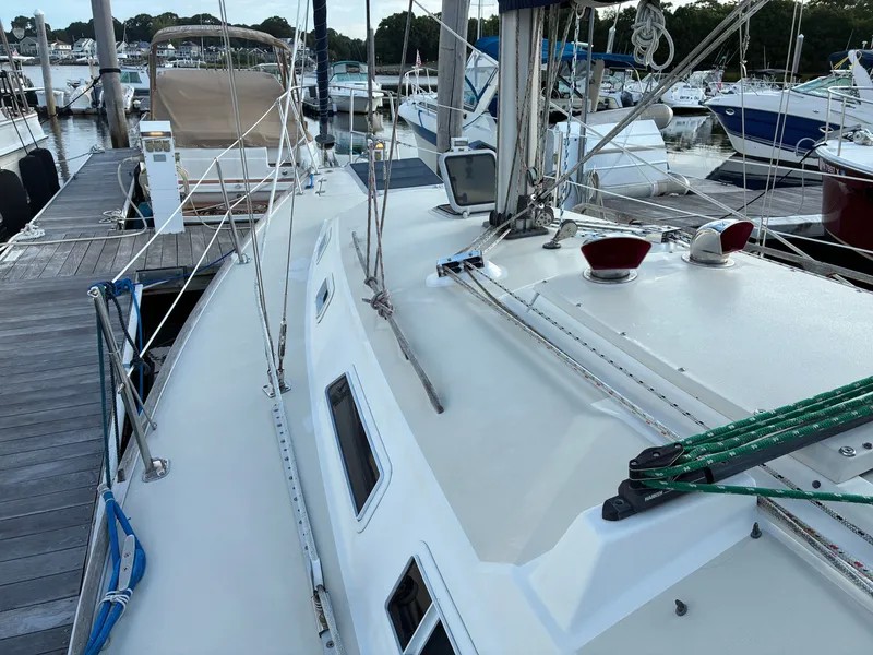 Slide: The Image of The image shows the deck of a 1988 Pearson 33-2 at a marina. - 8